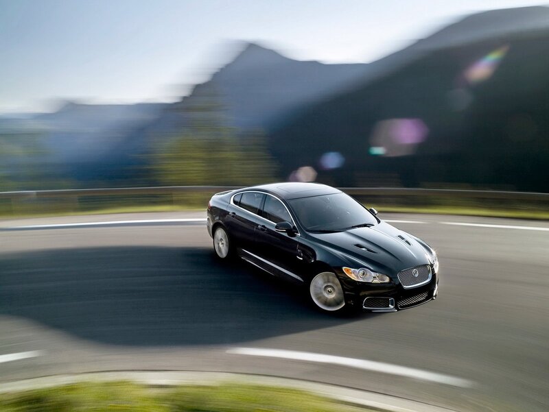 Black Jaguar driving on a mountain road