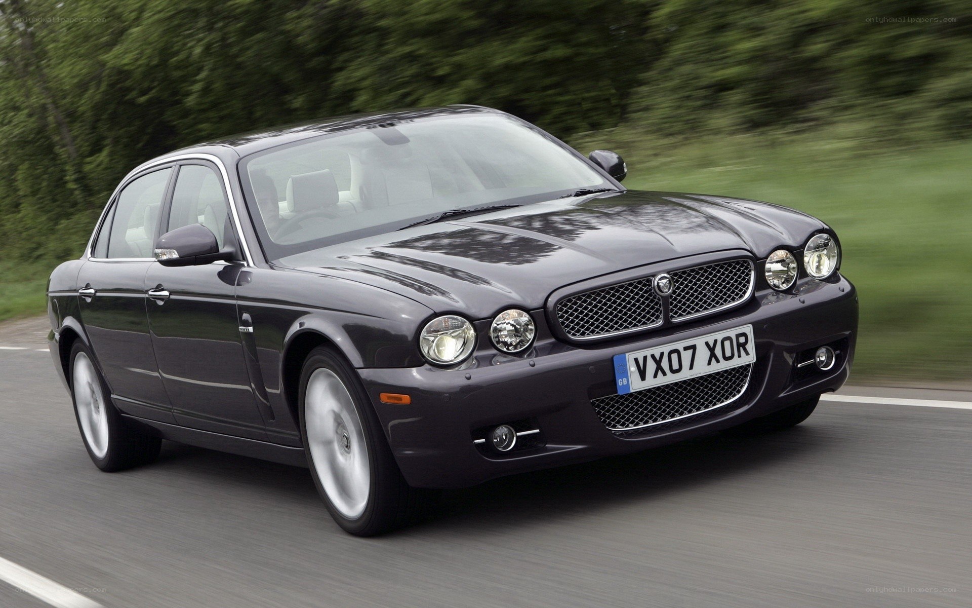 black jaguar driving on road
