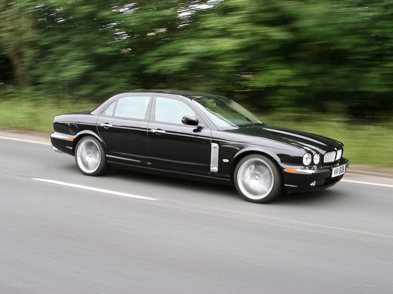 black jaguar driving on road