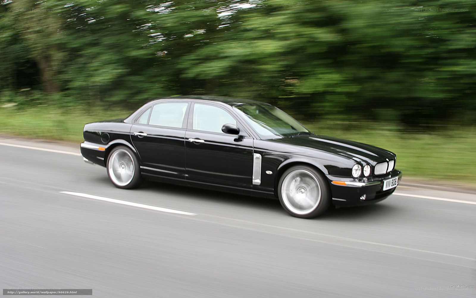 black jaguar driving on road