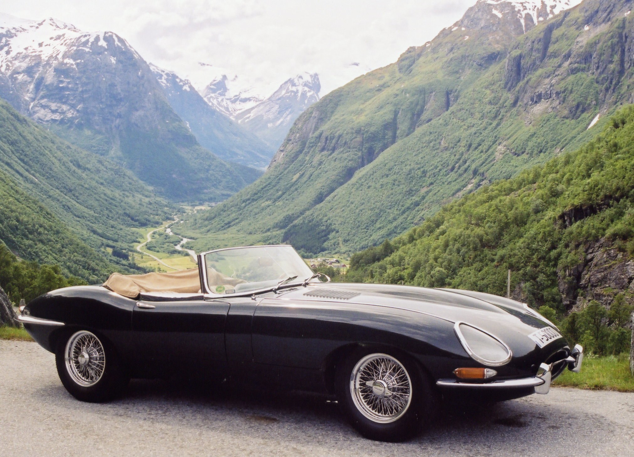 Black Jaguar E-Type in a mountain valley