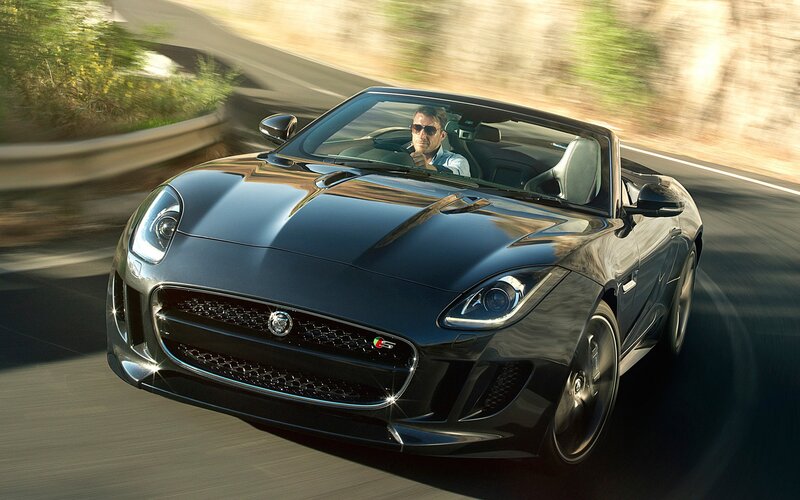 Black Jaguar F-Type driving on road