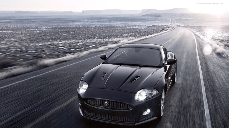 black jaguar speeding on desert road