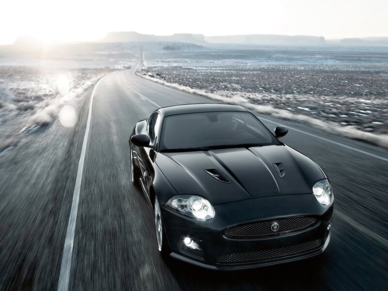 Black Jaguar speeding on desert road