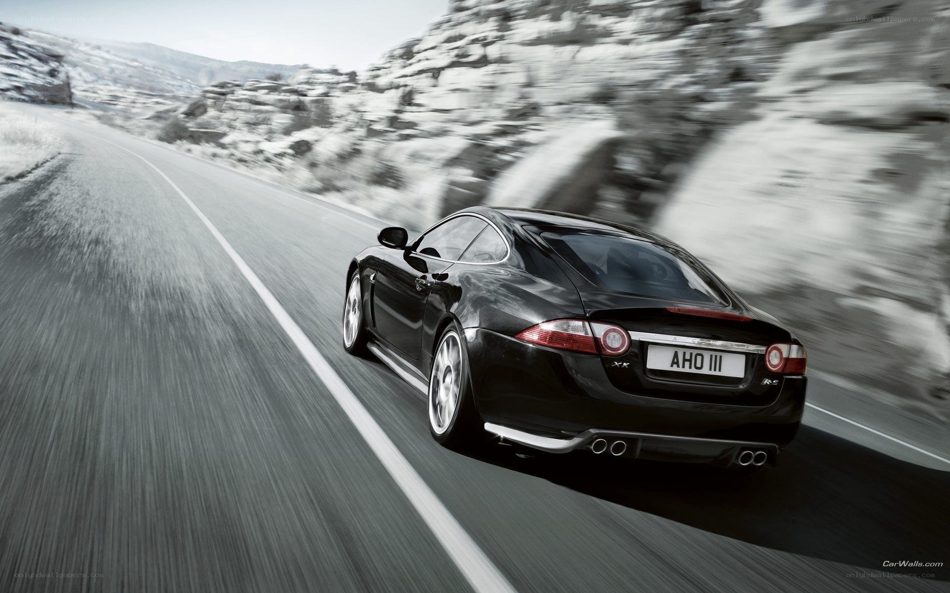 black jaguar speeding on road