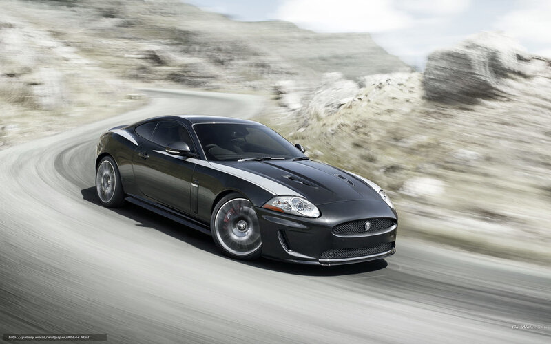 Black Jaguar sports car on mountain road