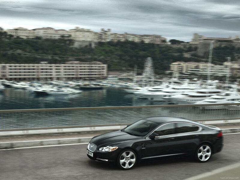Black Jaguar XF on a coastal road