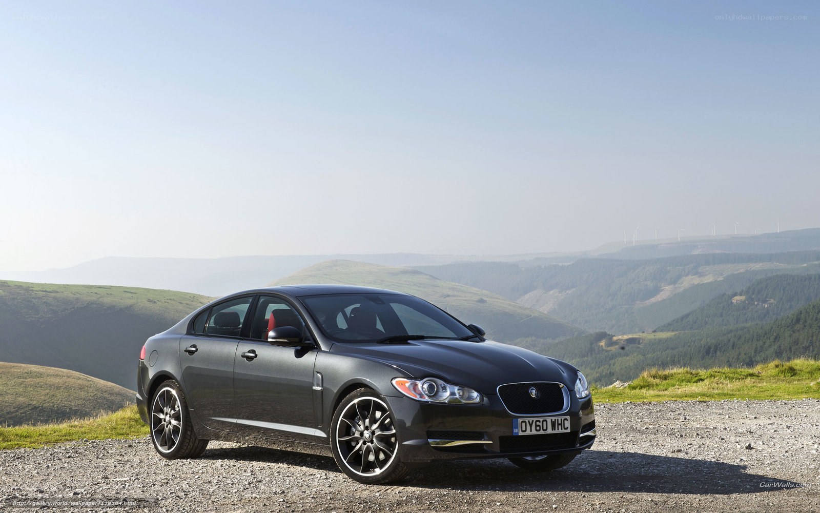 Black Jaguar XF on a hillside