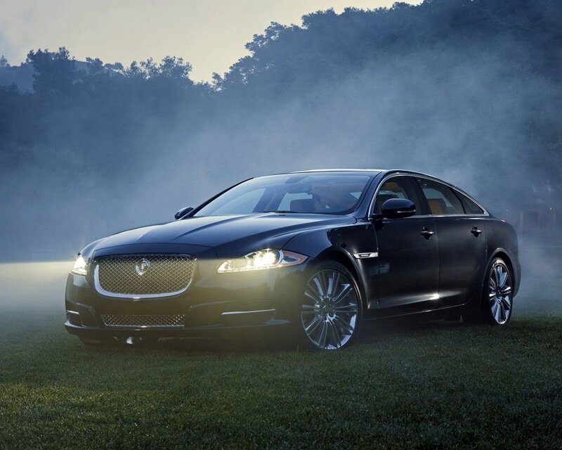 Black Jaguar XJ on a misty field