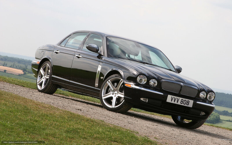 black jaguar xj8 on gravel path