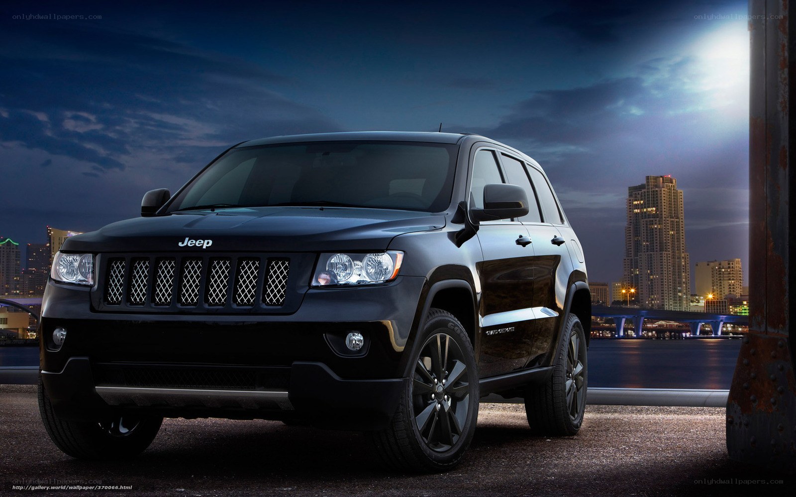 Black Jeep in city at night