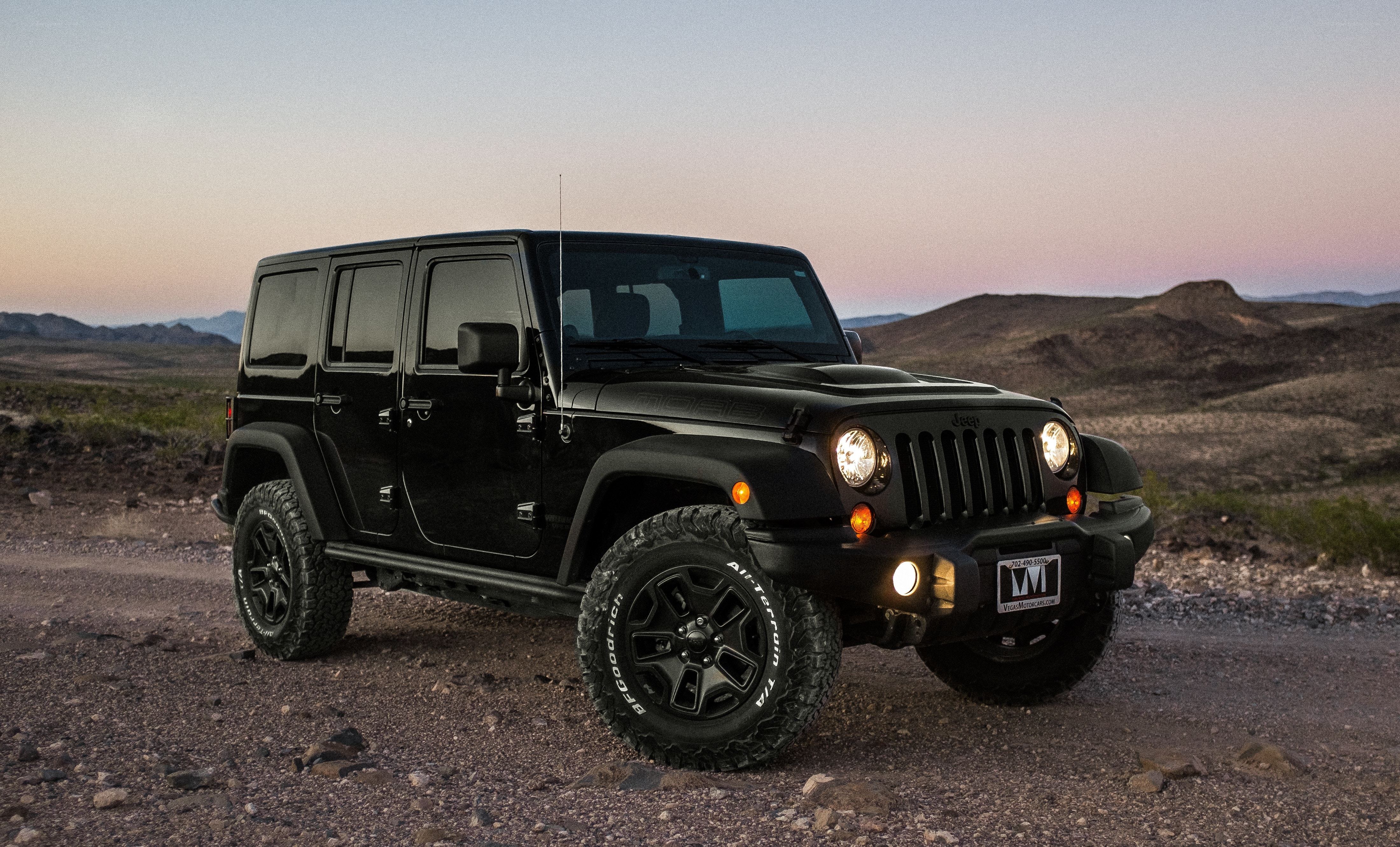 Black Jeep in desert at dusk