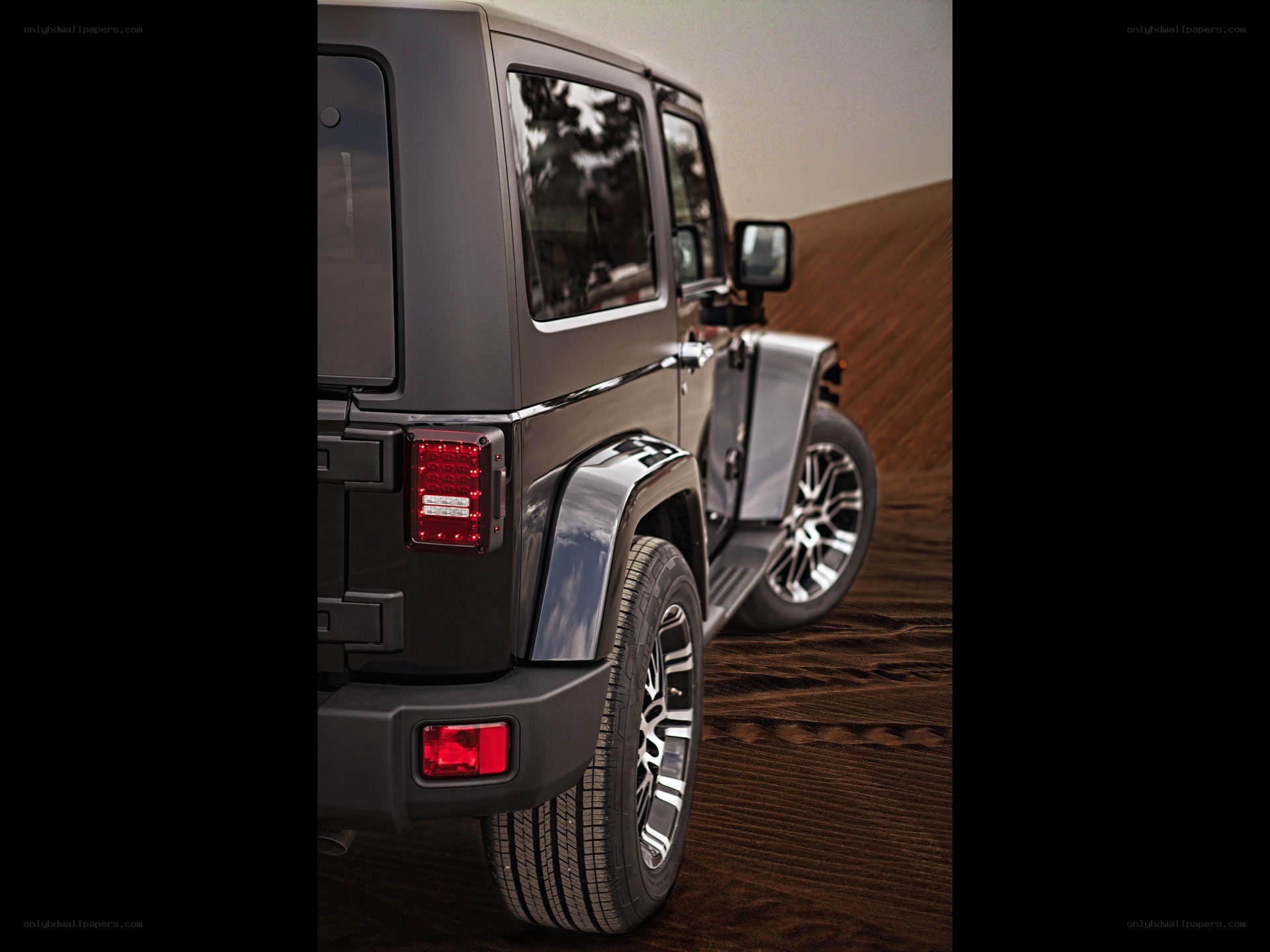black jeep on sand dune