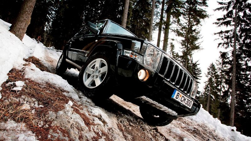 Black Jeep on snowy forest trail