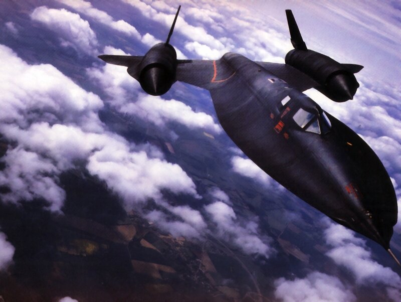 Black jet flying above clouds