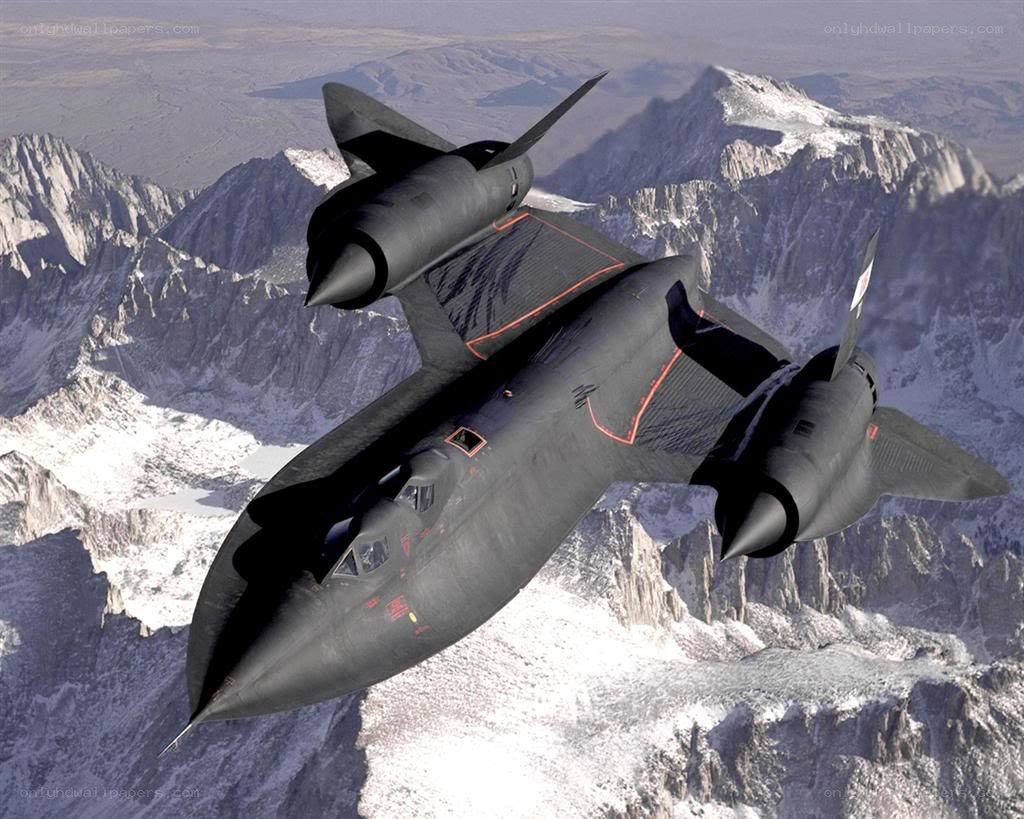 Black jet flying over mountains