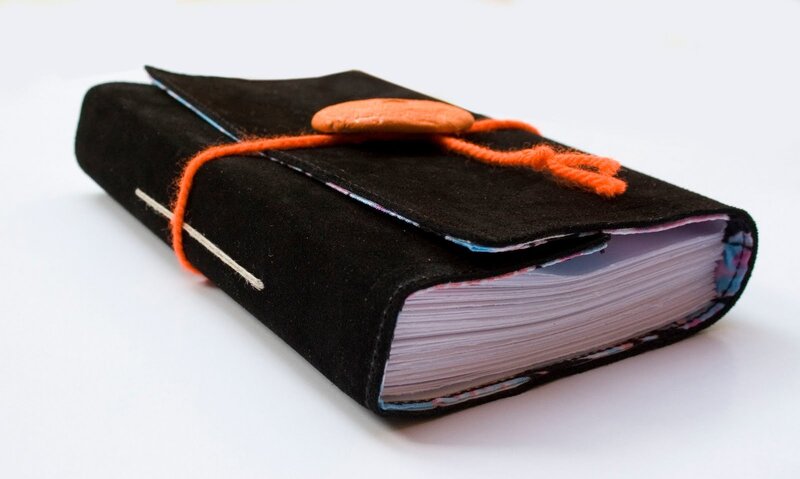 black journal with orange string