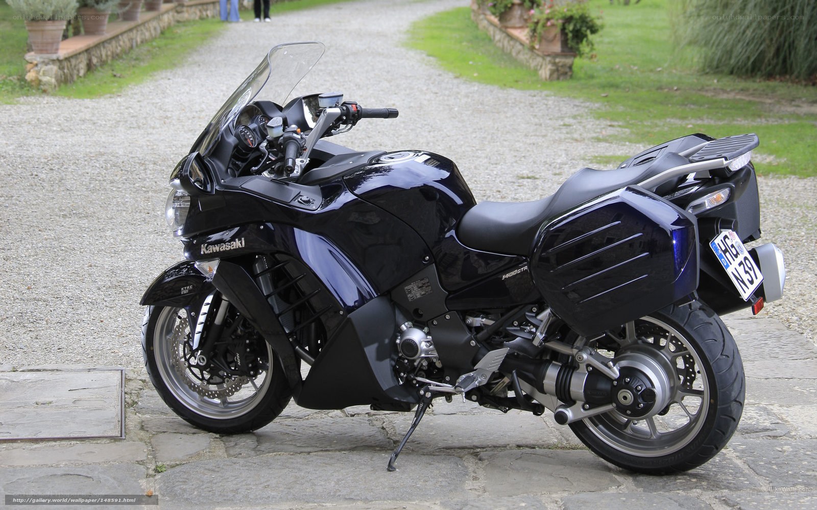 Black Kawasaki motorcycle on gravel path