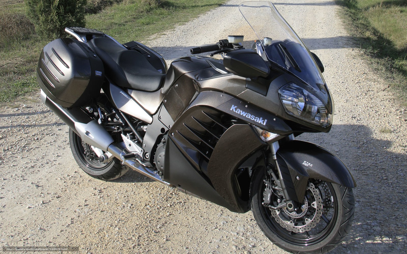 black kawasaki motorcycle on gravel