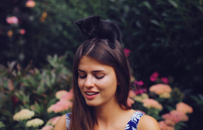 Black Kitten on Woman's Head