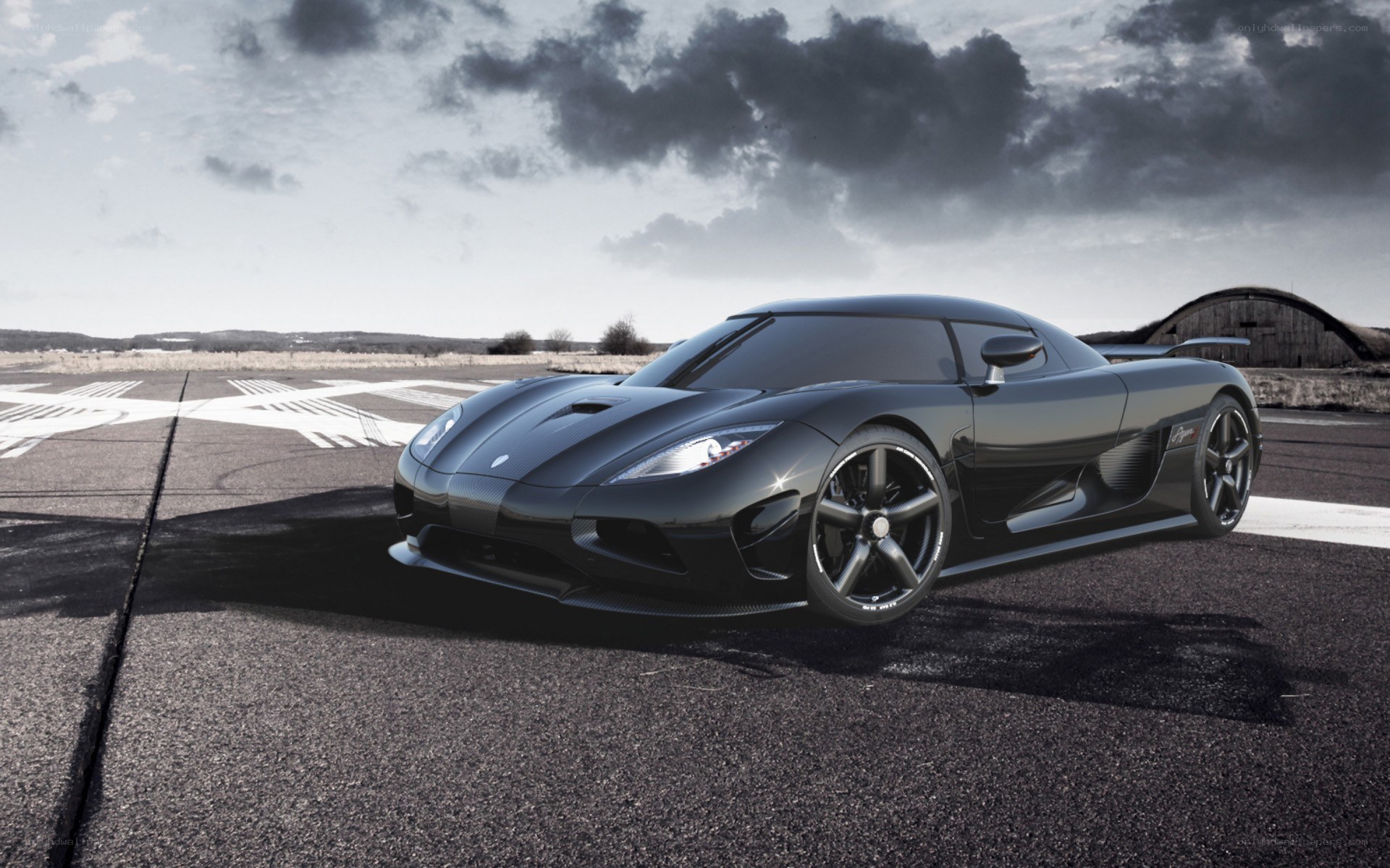 Black Koenigsegg on airstrip
