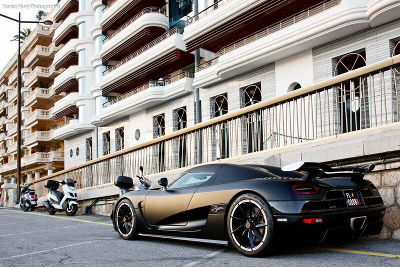 Black Koenigsegg parked on street