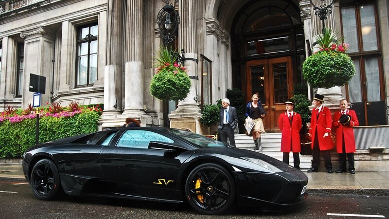 Black Lamborghini at hotel entrance