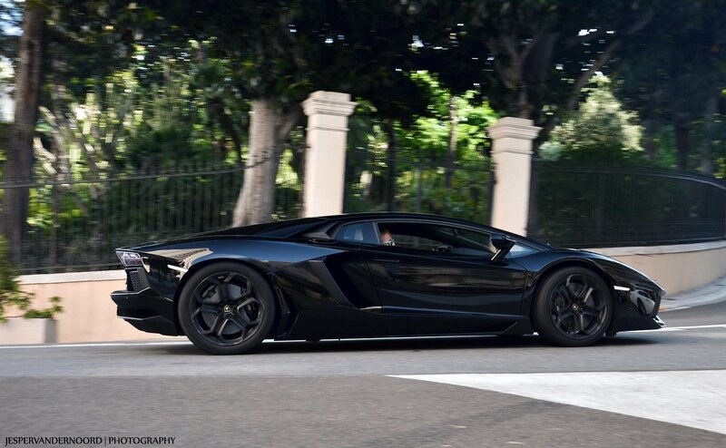 black lamborghini aventador in motion