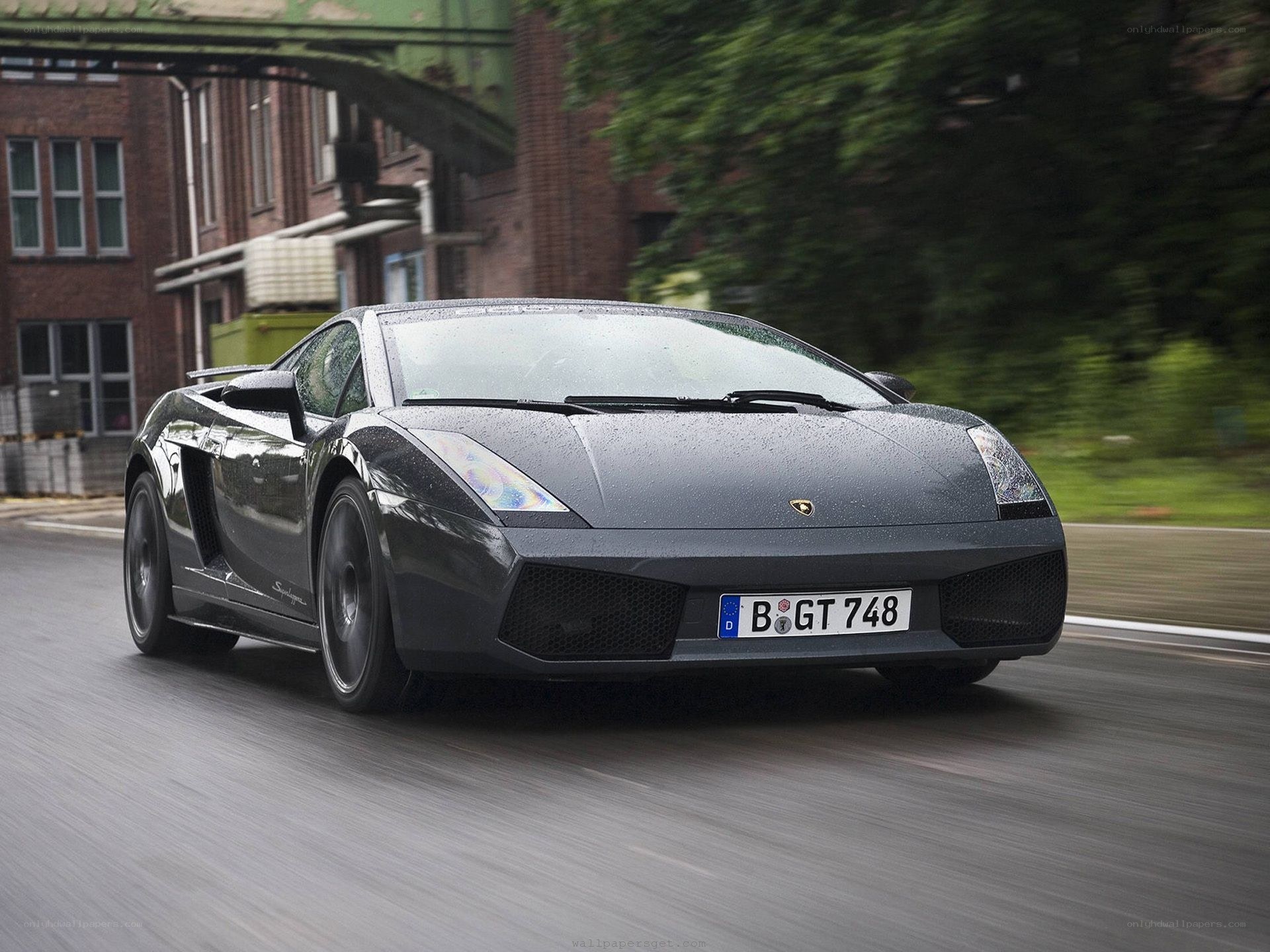 Black Lamborghini driving on road