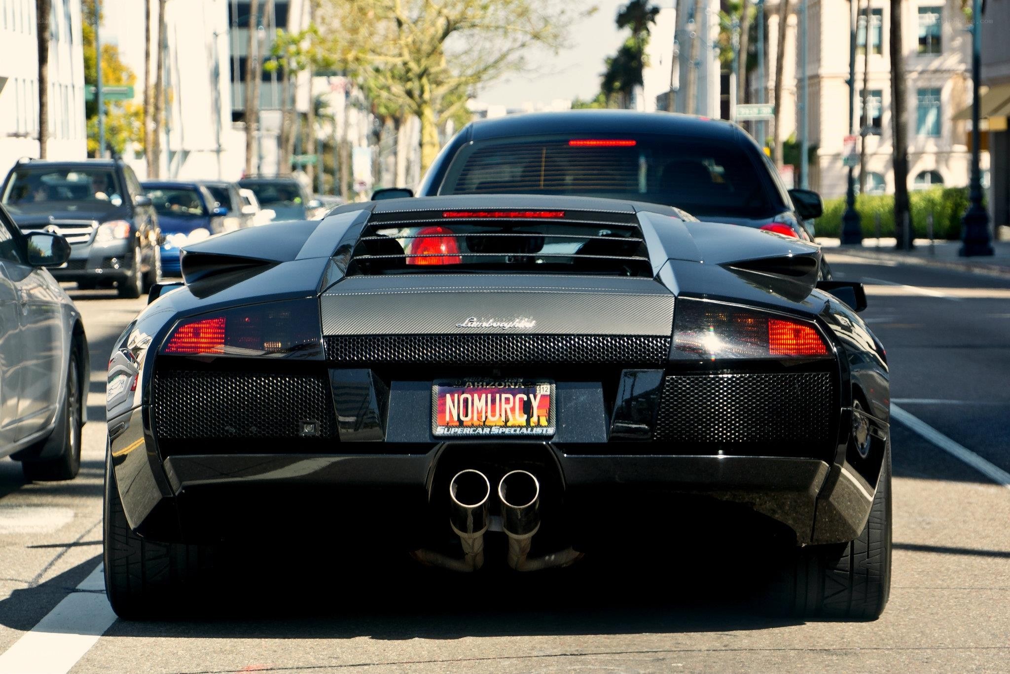Black Lamborghini in city traffic