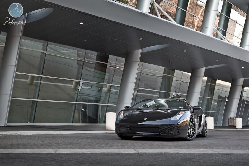Black Lamborghini in front of building