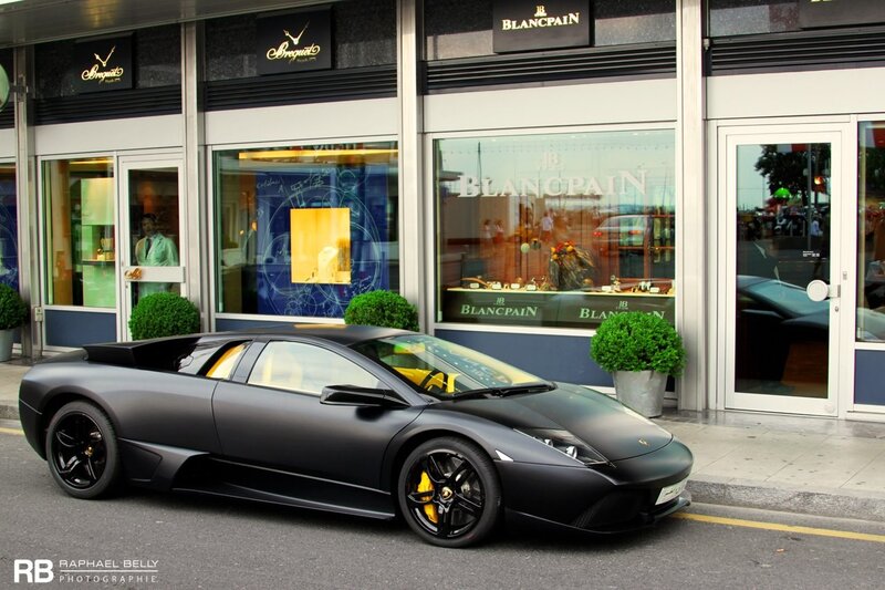 Black Lamborghini in front of luxury store