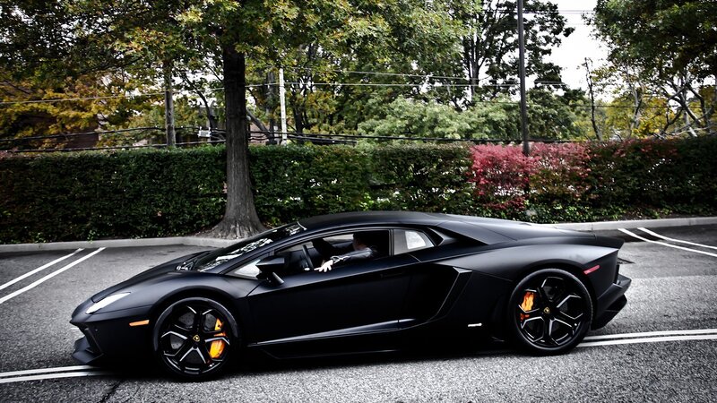 black lamborghini in parking lot