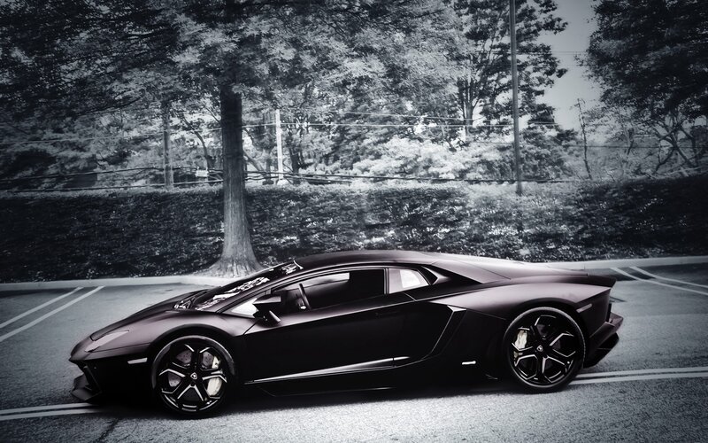 black lamborghini in parking lot