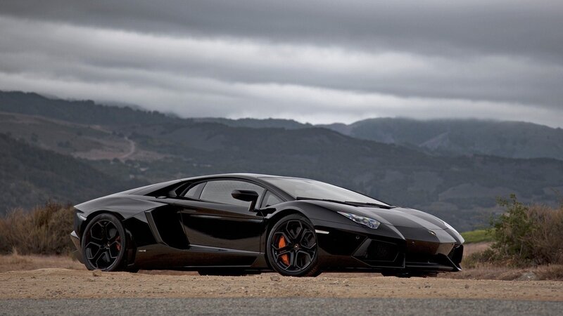 Black Lamborghini on a mountain road