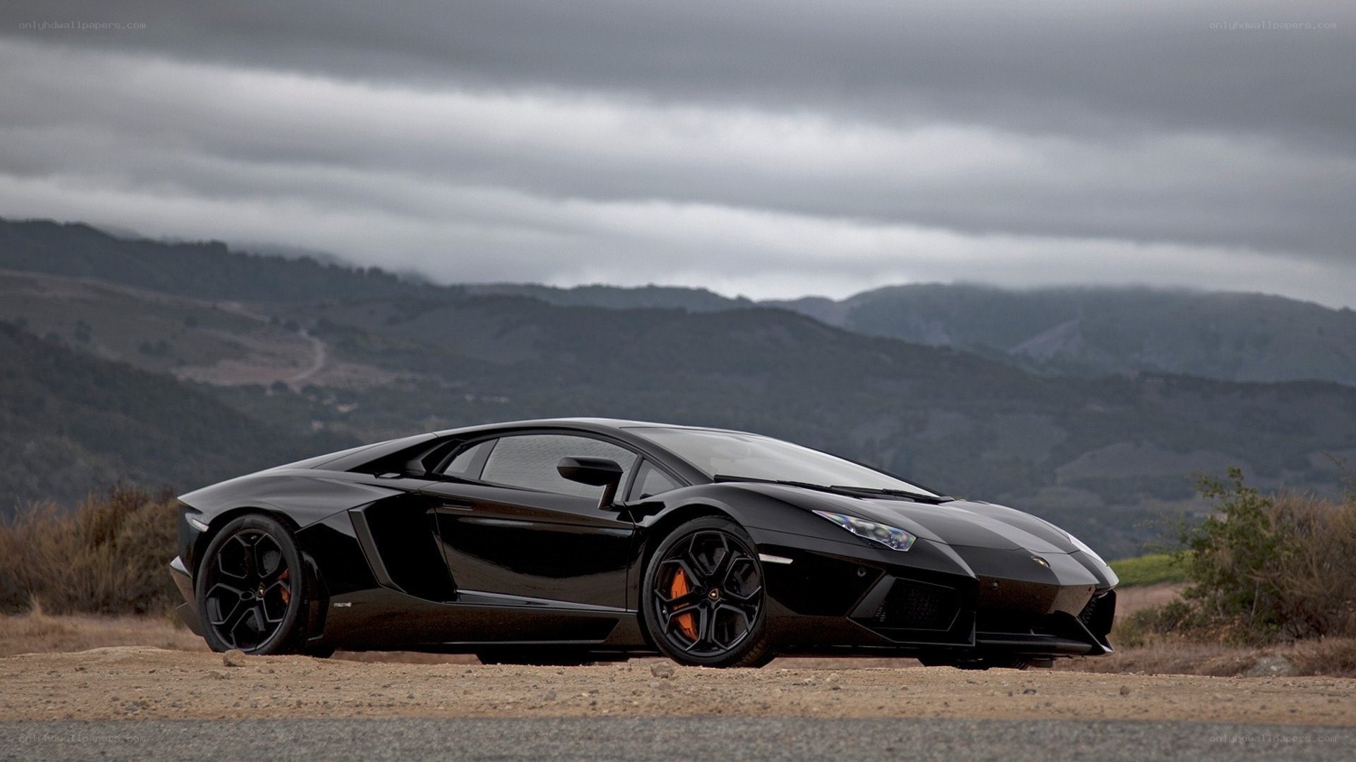 Black Lamborghini on a mountain road