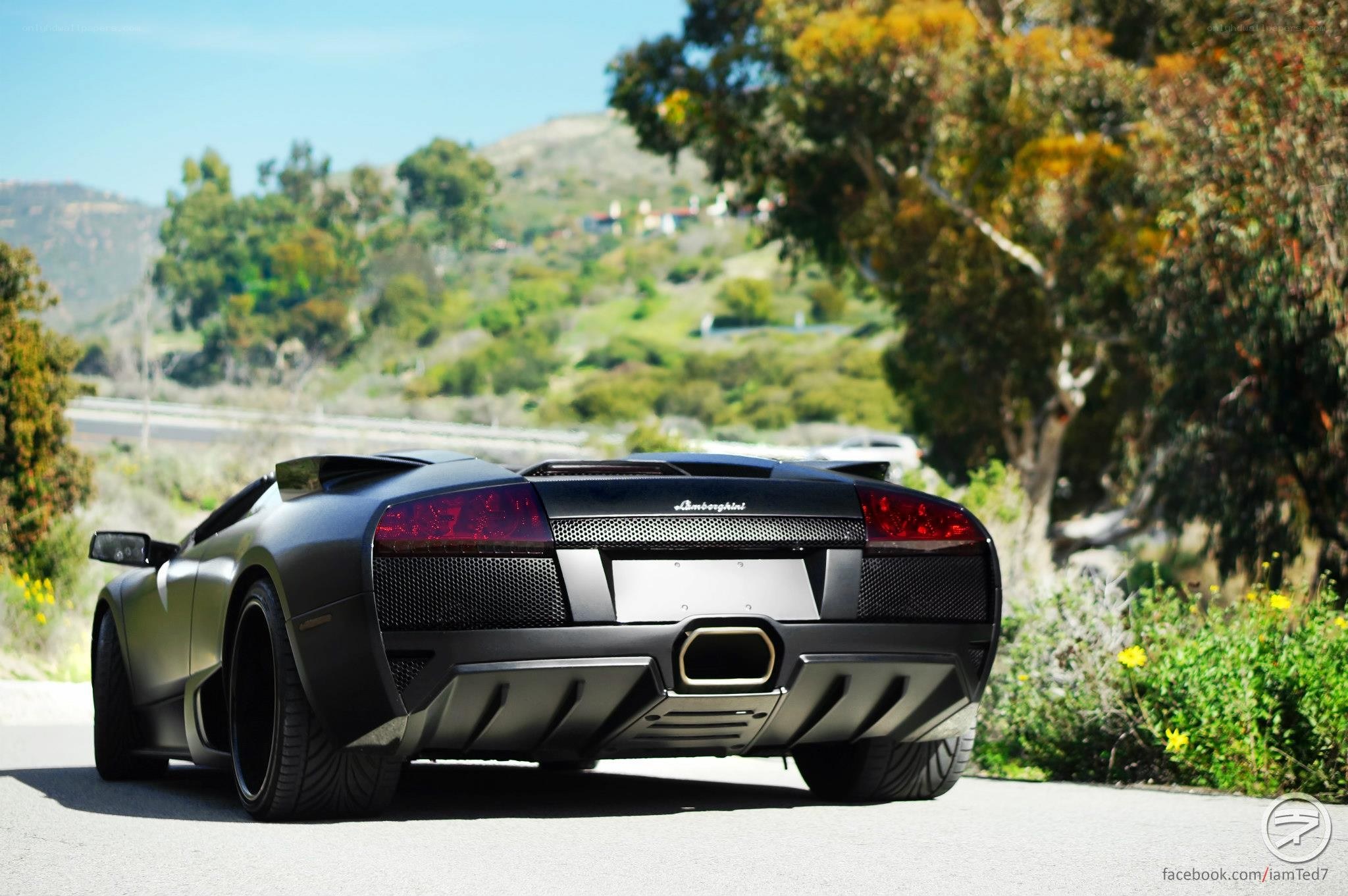 Black Lamborghini on a scenic road