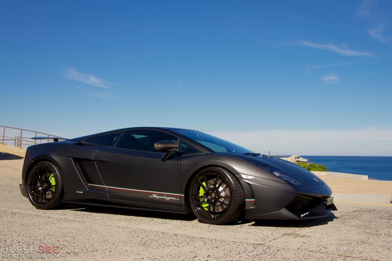Black Lamborghini on coastal road