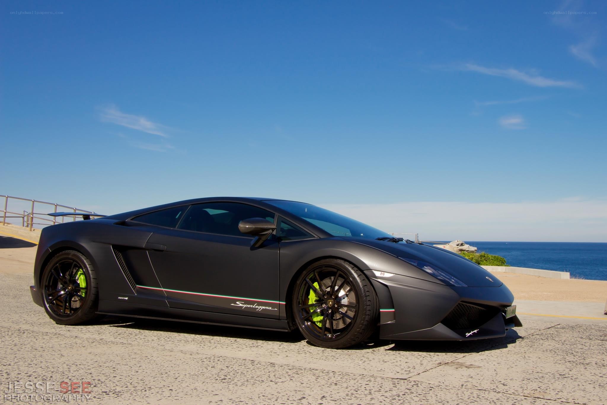 Black Lamborghini on coastal road