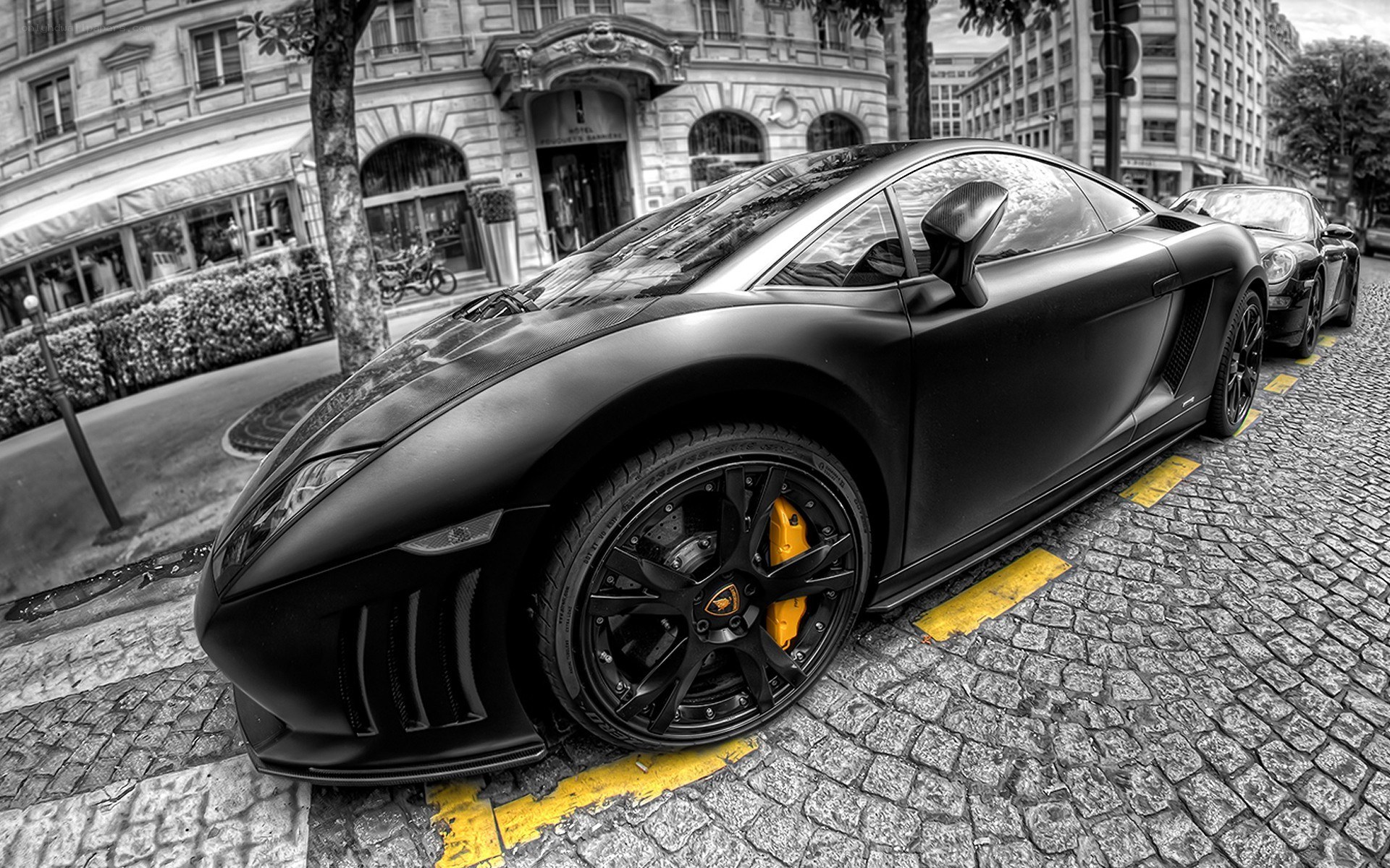 Black Lamborghini on cobblestone street