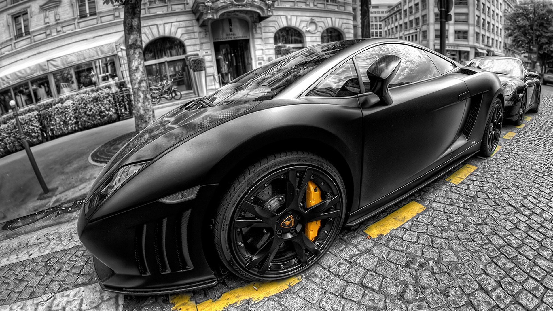 black lamborghini on cobblestone street