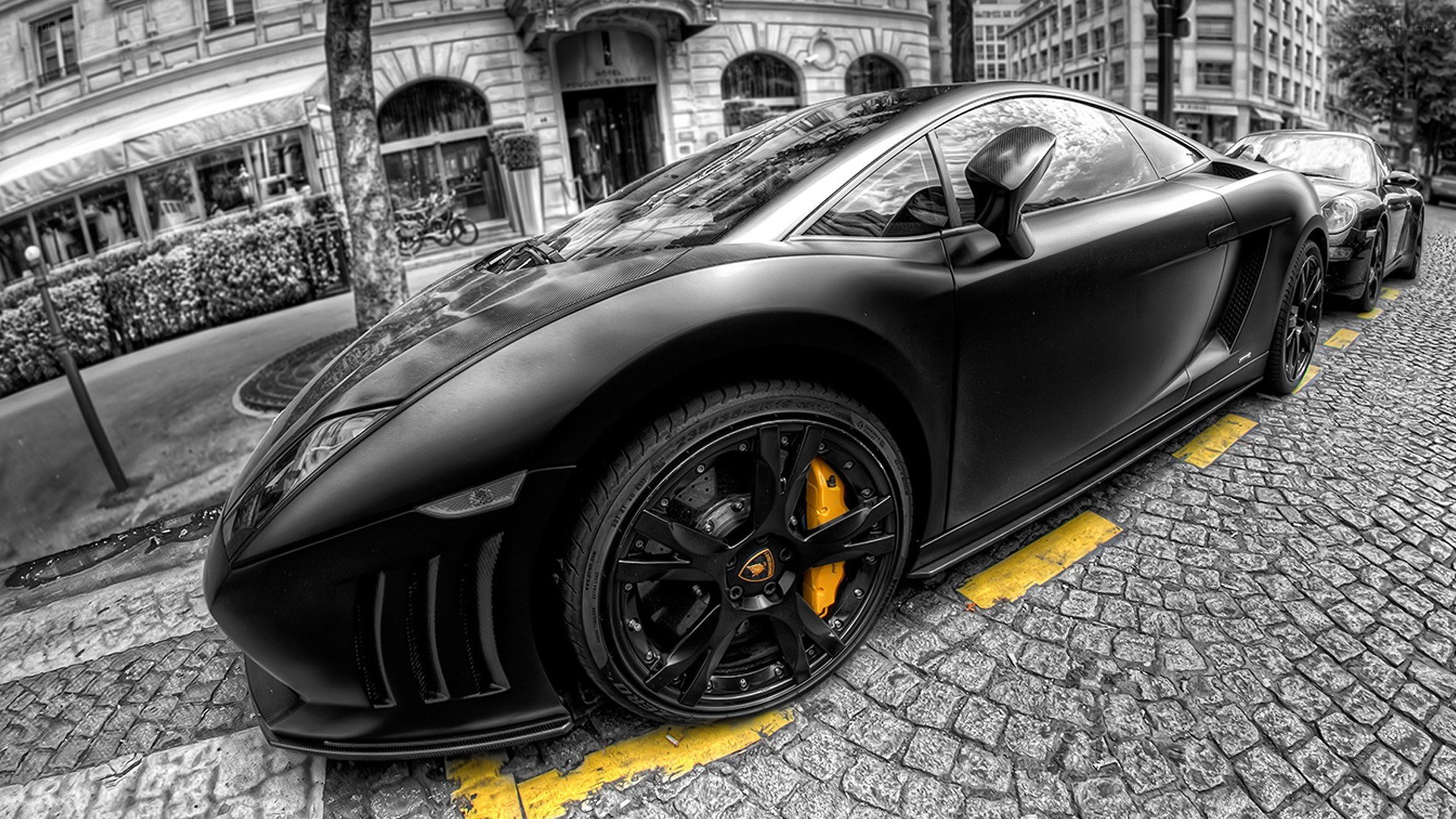 Black Lamborghini on cobblestone street