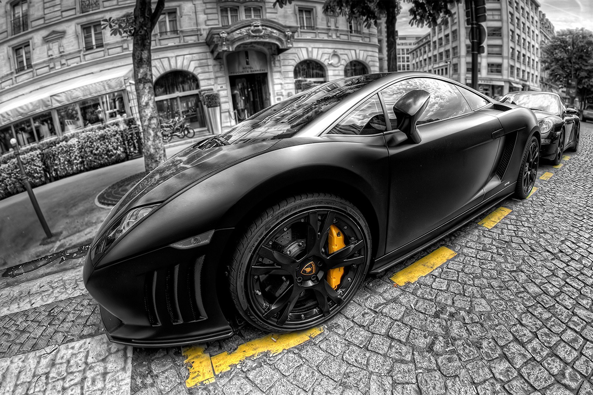 Black Lamborghini on cobblestone street