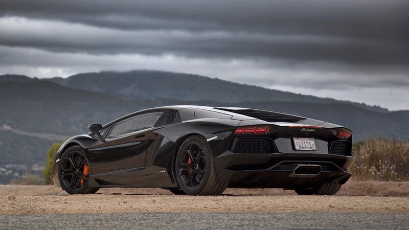 black lamborghini on dirt road
