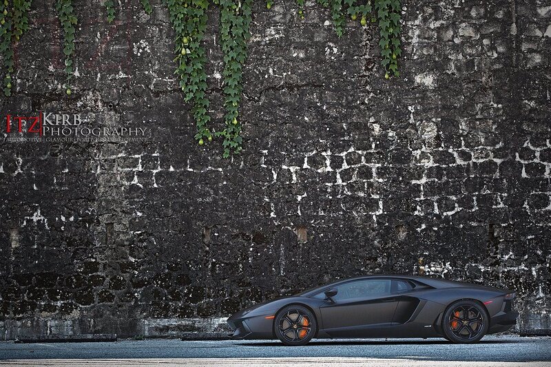 Black Lamborghini on stone wall