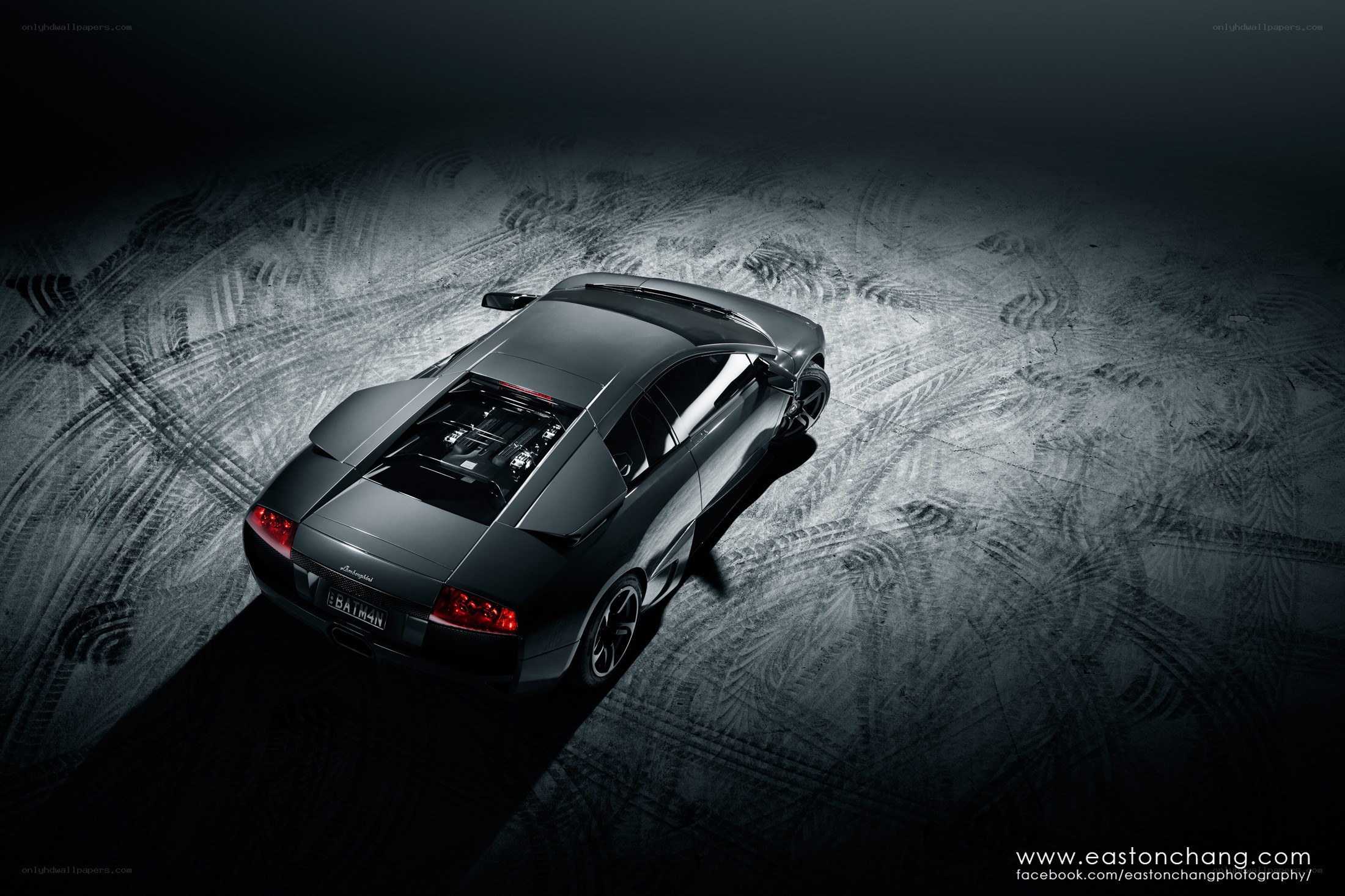 black lamborghini on tire tracks