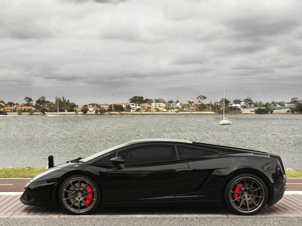 Black Lamborghini on waterfront