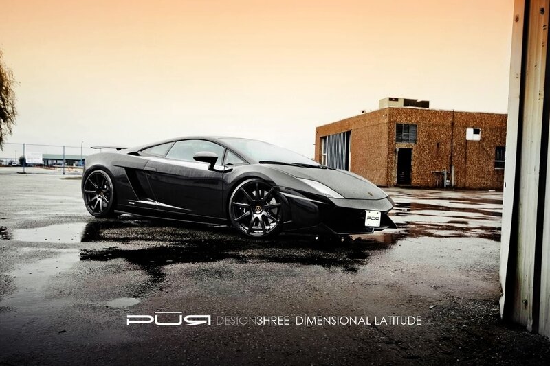 Black Lamborghini on wet pavement