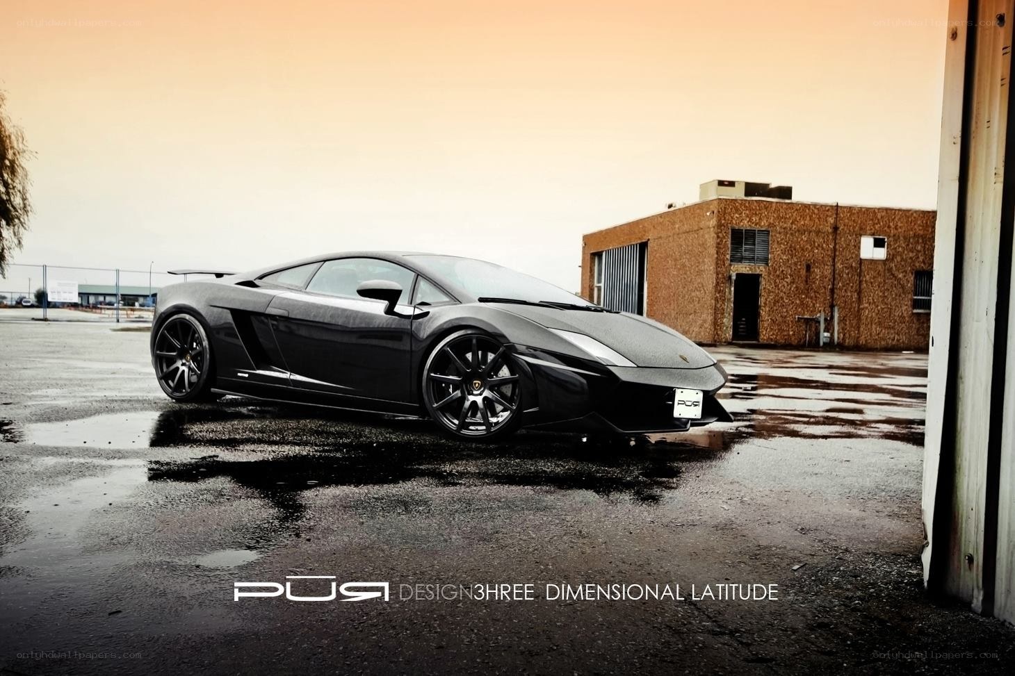 Black Lamborghini on wet pavement