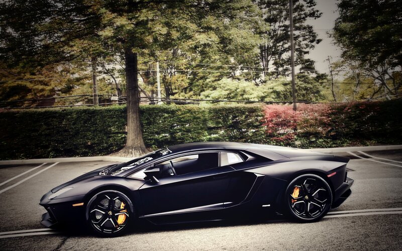 black lamborghini parked in lot